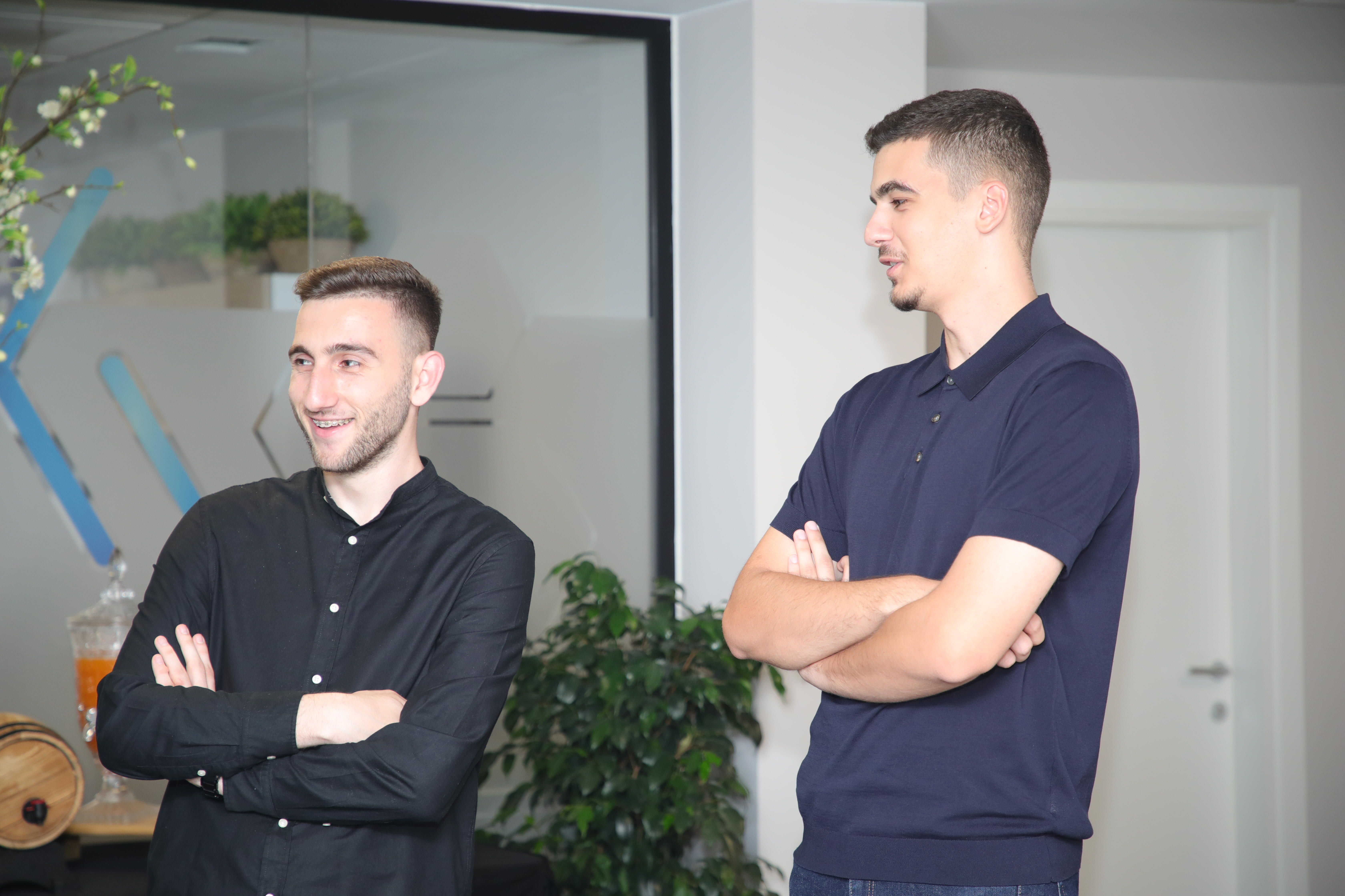Two Codevider team members smiling in the office